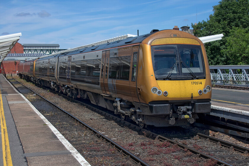 170514, LN 12.41 Shrewsbury-Birmingham New Street (2G17, RT), Shrewsbury station 
 When freshly applied the rather striking livery carried by West Midlands Trains' stock looked quite smart. However, as time has gone on it does not look quite so good looking as if it's become tricky to keep it smart. 170514 makes ready to leave Shrewsbury with the 2G17 12.41 service to Birmingham New Sreet. 
 Keywords: 170514 12.41 Shrewsbury-Birmingham New Street 2G17 Shrewsbury station London Northwestern West Midlands Trains