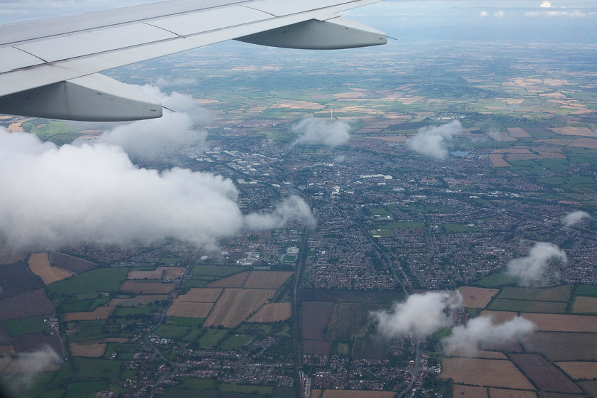 Aylesbury & Stoke Mandeville station, from flight VY0623 
 With the cloud juts beginning to come into view Aylesbury is seen from flight VY0623. In the foreground the railway stretches southwards with Stoke Mandeville station just visible. The green line under the large cloud to the far left is the single track route that goes to Pinces Risborough. 
 Keywords: Aylesbury Stoke Mandeville station from flight VY0623