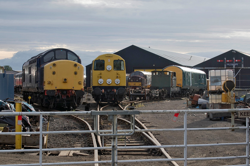 37703, 20020, 37214 & 82113, stabled, Bo`ness yard 
 The main yard of the Bo'ness and Kinneil Railway's headquarters sees many items of interest. There are three traditional heritage locomotives, from left to right, 37703, 20020 and 37214. To the far right is converted DVT 82113. This has been developed by Artemis for possible use on lines where electrification ends or is incomplete. It utilises a small JCB sourced diesel engine powering hydrostatic transmission with a form of regenerative braking that then stores the excess generated power in a set of on-board batteries. This battery power can then be used to supplement the diesel engine, thus making it a hybrid locomotive. 
 Keywords: 37703 20020 37214 82113 stabled Bo'ness yard