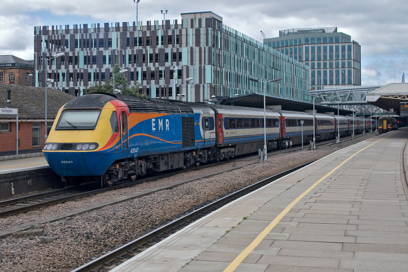 43047, EM 11.45 Nottingham-London St. Pancras (1B38, 3E), Nottingham station 
 Just travelling the short distance from Nottingham to Derby brought about a huge change in the weather, from bright sun and a clear sky to overcast and cloudy conditions! HST power car 43047 'Paxman VP185' waits to power the rear of the 11.45 service to St. Pancras. EMR has been gradually withdrawing its Paxman HST power cars with them being deemed as non-standard. As a West Country lad who grew up around all things hydraulic, this all sounds very familiar! To do this EMR has inherited a number of the former LNER East Coast MTU engined power cars as an interim arrangement prior to the introduction of new stock as a result of the electrification of the southern MML as far as Corby. 
 Keywords: 43047 11.45 Nottingham-London St. Pancras 1B38 Nottingham station HST Paxman VP185 East Midlands Railway EMR