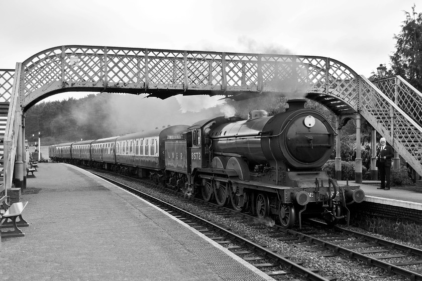 8572, 10.30 Sheringham-Holt, Weybourne station 
 I converted this image to black and white as it was a dull morning with very flat lighting; this format improves things! Ex. LNER B12 8572 arrives at Weybourne station with the 10.30 Sheringham to Holt service. The footbridge seen here was removed from Stowmarket station when the electrification wires were installed and now does a good job here at Weybourne. 
 Keywords: 8572 10.30 Sheringham-Holt Weybourne station