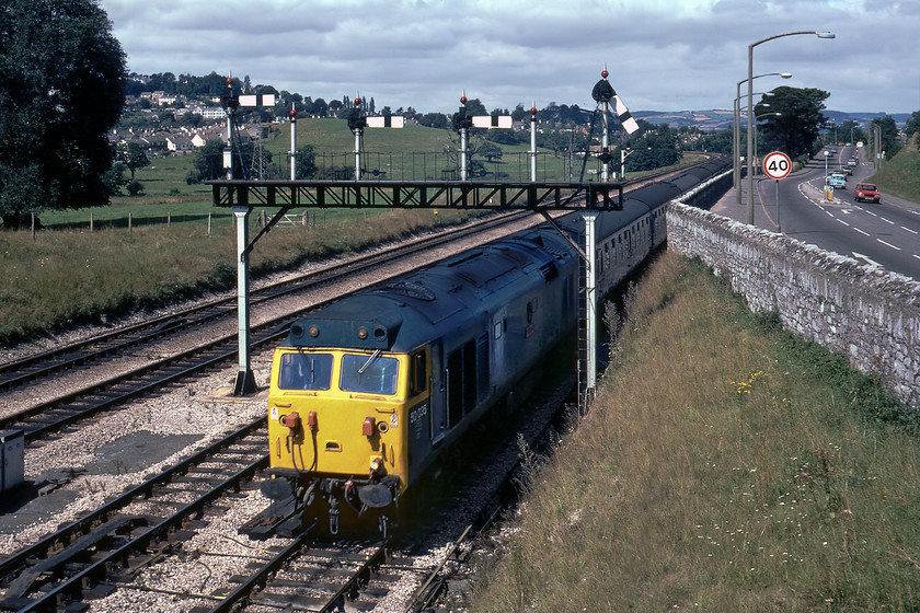 50035, unidentified Paignton working, Aller Junction 
 Having been held directly behind the previous Paignton working led by 47129, 50035 'Ark Royal' has just been given the road by the signalman in Aller Junction signal box. The driver has just opened up the power handle on the locomotive to get the train going again but shuts it down after he has passed hot on the heels of the previous train. For many, 50035 was the doyen of the class and would enter Doncaster works two months from when this photograph was taken for its much-needed refurbishment.

There is an audio recording of this event on my youtube channel, see..... https://youtu.be/26Lvlm6_fs0 
 Keywords: 50035 Paignton working Aller Junction Ark Royal