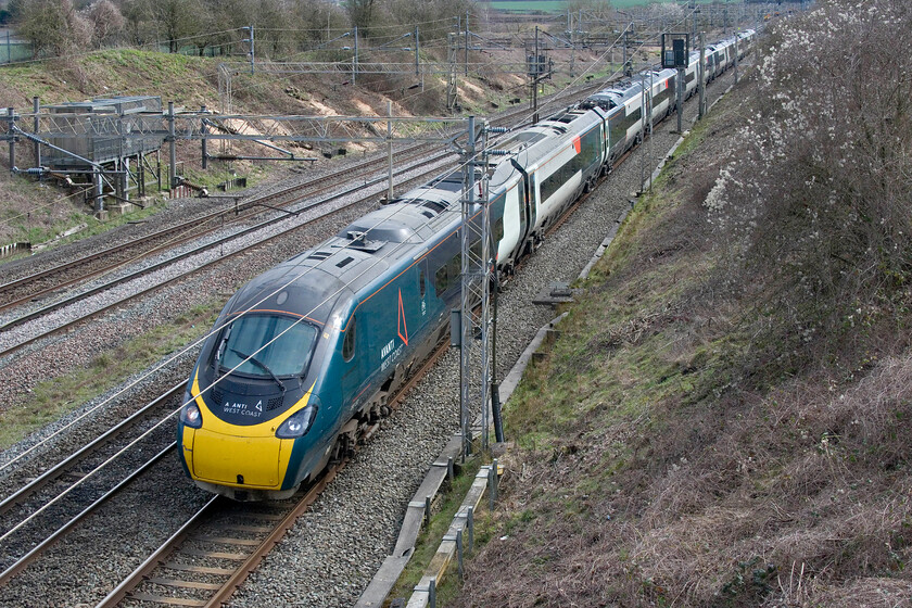 390152, VT 12.08 London Euston-Manchester Piccadilly (1H19, 2L), Victoria bridge 
 390152 passes a newly opened up scene at Victoria bridge just south of Roade working the 1H19 12.08 Euston to Manchester Piccadilly in some welcome if a little weak, spring sunshine. Notice that some wag has removed the letter V of the nose vinyl thus creating a new TOC named A ANTI! 
 Keywords: 390152 12.08 London Euston-Manchester Piccadilly 1H19 Victoria bridge Avanti west Coast Pendolino