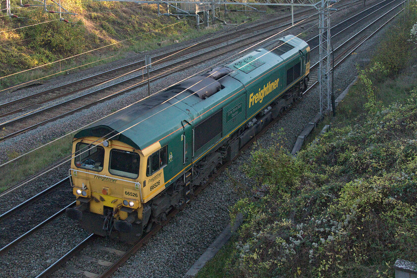 66526, 13.47 Wembley Yard-Lawley Street (0Z56, 85E), Victoria bridge 
 66526 'Driver Steve Dunn (George)' passes Victoria bridge south of Roade as the 13.56 Wembley Yard to Lawley Street 0Z56 light engine working. The routing of this locomotive here is a little unusual and nearly caught me out as control decided to put it on the down fast line from Hanslope Junction (about three miles south of this point). This decision meant that the loco. would avoid Northampton thus meaning that any enthusiasts hoping to capture it on the loop would have been disappointed! 
 Keywords: 66526 13.47 Wembley Yard-Lawley Street 0Z56 Victoria bridge Freightliner Driver Steve Dunn (George)