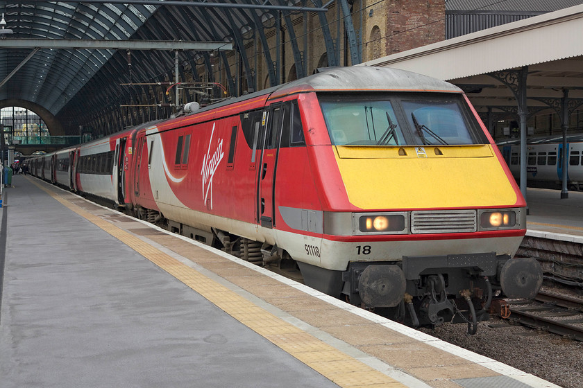 91118, GR 16.30 London Kings Cross-Edinburgh (1S25), London Kings Cross station 
 91118 waits to leave King's Cross leading the 1S25 16.25 to Edinburgh. Out of all the liveries carried by these trains over the years the Virgin East Coast one looks particularly smart. It is likely that this will be their last reincarnation until they are replaced by the IETs at the end of 2018 and the start of 2019. However, what will happen to these far from life-expired train sets after that is anybody's guess; too good to scrap surely? 
 Keywords: 91118 16.30 London Kings Cross-Edinburgh 1S25 London Kings Cross station