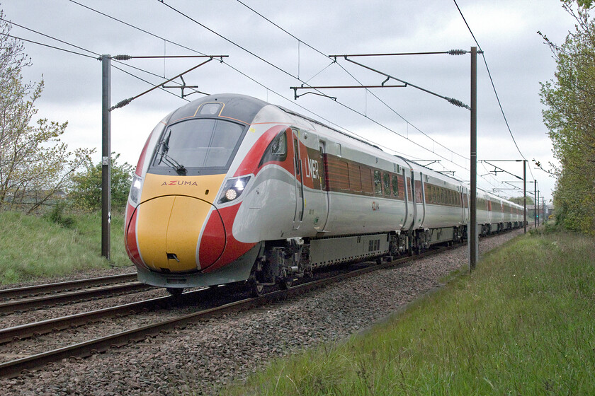 800110, GR 08.00 Edinburgh Waverley-London King's Cross (1E06, 1E), Penny's crossing SK630970 
 The 08.00 Edinburgh to King's Cross LNER service is some two hundred and forty-three miles into its journey here at Penny's foot crossing a short distance south of Doncaster. It is being worked by Azuma 800110 that, in this view, reveals the jacking points attached to the side of body structure underneath the doors that was where the cracking was discovered that caused the entire fleet to be withdrawn from service for investigation. 
 Keywords: 800110 08.00 Edinburgh Waverley-London King's Cross 1E06 Penny's crossing SK630970 LNER Azuma