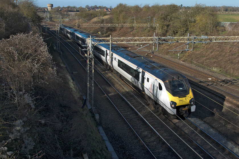 221101, VT 12.30 Birmingham New Street-London Euston (1B44, 3L), Victoria bridge 
 I am not at all clear what Avanti West Coast's livery strategy is at the present time. Since taking over the franchise at the start of December 2019 a small number of Pendolinos have been in receipt of their new-look green, black and orange livery. The majority remain in the plain white paintwork as applied by Virgin in the final six months of its operations. As for the Class 221 Voyagers, the situation is different. Most remain in Virgin's red livery that they have worn for many years. However, this one, 221101 has become somewhat of a celebrity being the only one in the white paintwork with Avanti branding and was the only example that Virgin applied its flowing silk variant livery to. If you can make sense of this please do get in contact! 221101 '101 Squadron' passes Victoria bridge just south of Roade with the 12.30 Birmingham New Street to Euston. 
 Keywords: 221101 12.30 Birmingham New Street-London Euston 1B44 Victoria bridge Avanti West Coast Voyager