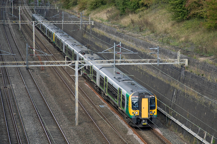 350115 & 350103, LM 11.37 Crewe-London Euston (1U30), Roade cutting 
 At weekends and, in particular on Sundays, London Midland's Crewe to London return services take the Northampton loop rather than shooting around the Weedon line as they do in the week. This has quite an effect on their timings taking an extra twenty minutes to make the journey. 350115 and 350103 climbs through Roade cutting working the 1U30 11.37 Crewe to Euston. 
 Keywords: 350115 350103 11.37 Crewe-London Euston 1U30 Roade cutting London Midland Desiro