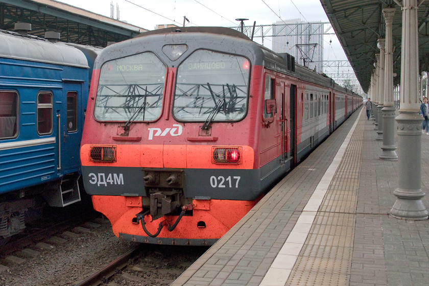 ZDM-0217, unidentified Odintsovo-Moscow Belorussky working, Moscow Belorussky station 
 Next to a set of Belerus Railways stock in the adjacent platform, one of the many ZDM EMUs arrives at Moscow's Belorussky station. ZDM-0217 is coming to a halt with an unidentified service from Odintsovo one of the wealthiest suburbs to the west of Moscow. 
 Keywords: ZDM-0217 Odintsovo-Moscow Belorussky working Moscow Belorussky station