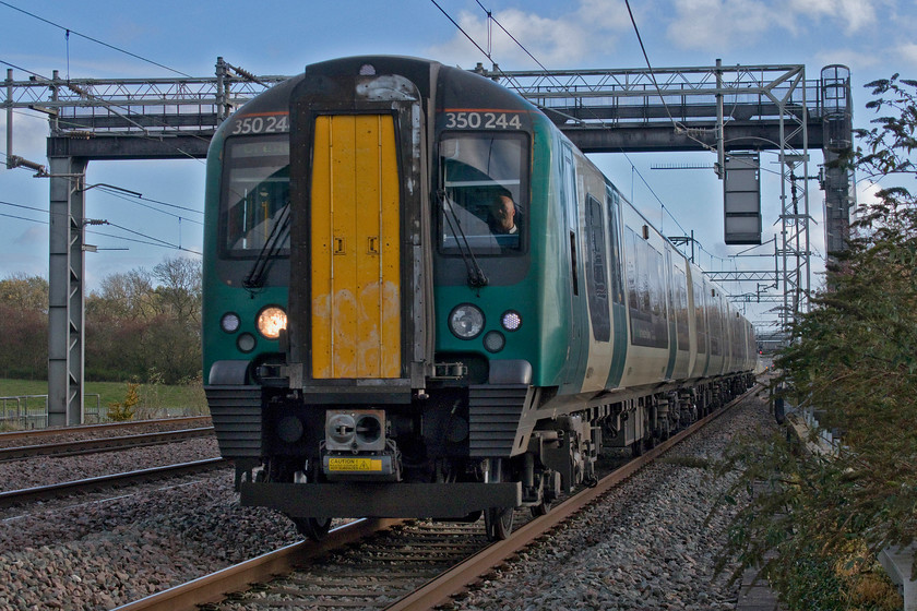 350244, LN 12.36 London Euston-Crewe (1U35, 1L), Cathiron SP4667783 
 350244 passes Cathiron on the down fast line forming the 12.36 Euston to Crewe London Northwestern service. Cathiron is a classic location visited by many photographers over the years. However, the installation of palisade fencing means that the use of a ladder is essential unless the camera can be poked through the fence utilising a flip-out screen as I have used here. 
 Keywords: 350244 12.36 London Euston-Crewe 1U35 Cathiron SP4667783 London Northwestern Desiro