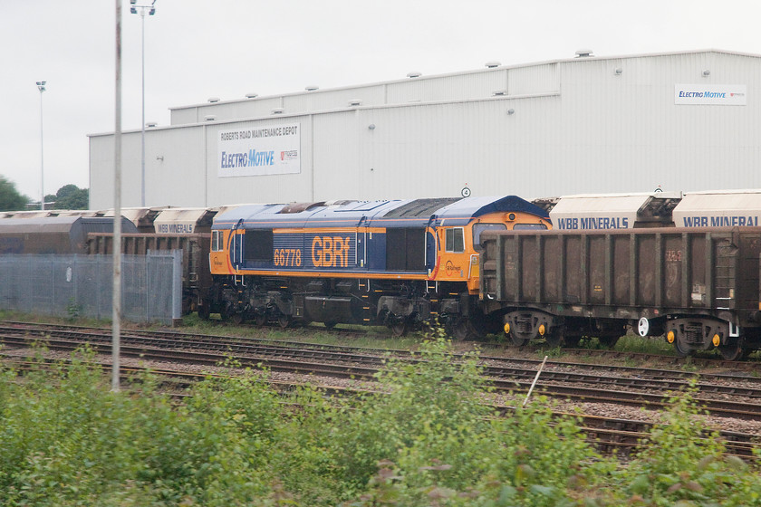 66778, stabled, Doncaster Hexthorpe sidings 
 66778 sits sandwiched between sets of wagons in Doncaster Hexthorpe sidings just to the south of the station. 
 Keywords: 66778 Doncaster Hexthorpe sidings