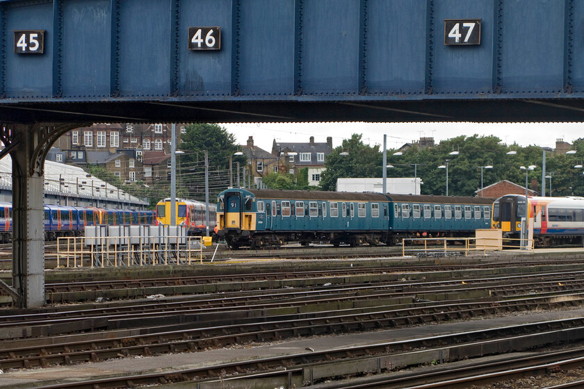 3417, stabled, Clapham Junction 
 In Claphams Yard Sidings 4VEP (43) 3417 Gordon Pettitt is seen stabled with its ten years old reproduction as delivered paintwork now looking a little faded. It is owned by the Bluebell Railway and in the care of the Southern Electric Traction Group (SETG) who are likely to completely restore it and return it to mainline operation. However, prolonged storage outside will make this job more difficult to undertake so let's hope that it moves to a more protective location sooner than later. 
 Keywords: 3417 Clapham Junction 4VEP 3417