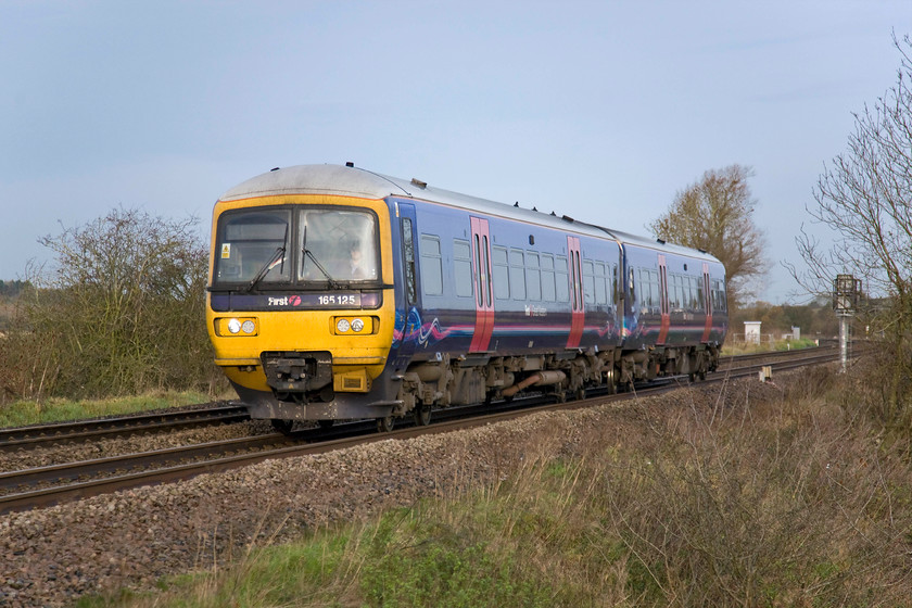 165125, GW 09.08 Banbury-Oxford (2L39), King's Sutton 
 Still wearing its First Great Western livery some months after the company ceased to operate one of the small numbers of trains that run to and from Banbury using two-car Turbo units is seen approaching King's Sutton. The services operate an all-station service between Banbury and Oxford running every two hours or so. 165125 is working the 09.08 Banbury to Oxford train seen from a former farmer's crossing point on the floodplains of the River Cherwell. Interesting fact time......King's Sutton is the only station that Great Western Railway (the new TOC from September this year) serves in Northamptonshire if only by a matter of a few metres with the county boundary running just west of the down platform. 
 Keywords: 165125 09.08 Banbury-Oxford 2L39 King's Sutton First Great Western Turbo