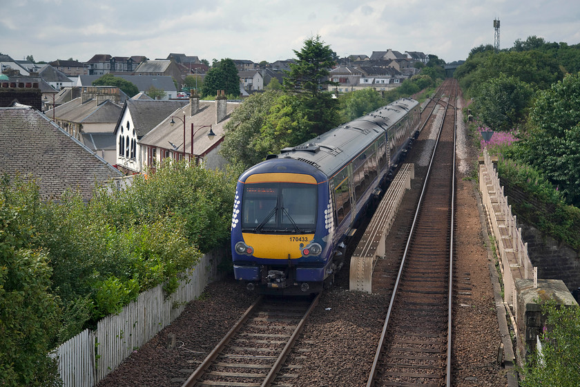 170433, SR 10.40 Glenrothes with Thornton-Edinburgh Waverley (2G08, 2L), Cowdenbeath station 
 The town of Cowdenbeath has a proud history of mining with many former mines in the area. Now, with them all closed, people have had to look elsewhere for work with the excellent railway service enjoyed by the town's fourteen thousand population has helped with this. 170433 leaves the station with the 10.40 Glenrothes with Thornton to Edinburgh service. 
 Keywords: 170433 10.40 Glenrothes with Thornton-Edinburgh Waverley 2G08 Cowdenbeath station