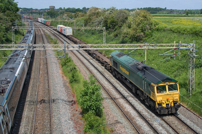 66515, 09.52 Lawley Street-Felixstowe North (4L99, 12L) & 390141, VT 11.28 London Euston-Manchester Piccadilly (1H76, 2L), Victoria bridge 
 With one of the Avanti West Coast services that was actually able to run on this strike-riven day heading north 66515 passes southwards leading the 4L99 09.52 Lawley Street to Felixstowe Freightliner. The Pndolino was working the 11.28 Euston to Manchester service worked by 390141. Notice that the sun has come out from behind the clouds for this photograph unlike the last one in this sequence! 
 Keywords: 66515 09.52 Lawley Street-Felixstowe North 4L99 390141, VT 11.28 London Euston-Manchester Piccadilly 1H76 Victoria bridge Freightliner AWC Avanti Pendolino