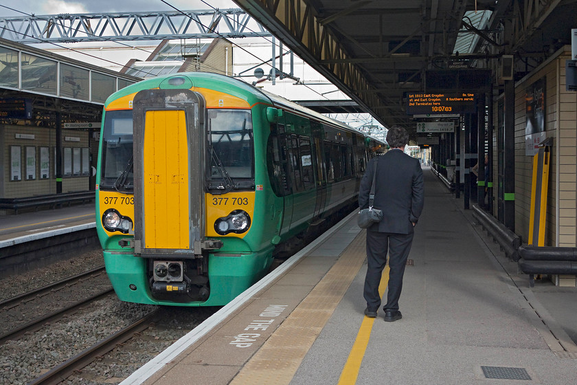 377703, 10.13 Milton Keynes Central-East Croydon (2031, RT), Milton Keynes Central Station 
 The conductor surveys a very quiet platform at Milton Keynes waiting to board his train, give it the right away and head south from Milton Keynes Central. The service, the 10.13 to east Croydon, is formed of Electrostar 377703. 
 Keywords: 377703 2031 Milton Keynes Central Station