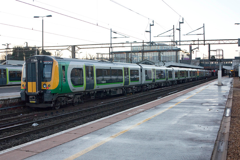 350243, ECS for 07.10 Northampton-London Euston (1Y84), Northampton station 
 350243 has just come down from the Kingsheath EMUD depot and is joining a classmate already on platform one. The duo will then work the 1Y84 07.10 to London Euston. The sky in the background is bright but the sun is yet to rise. 
 Keywords: 350243 07.10 Northampton-London Euston 1Y84 Northampton station