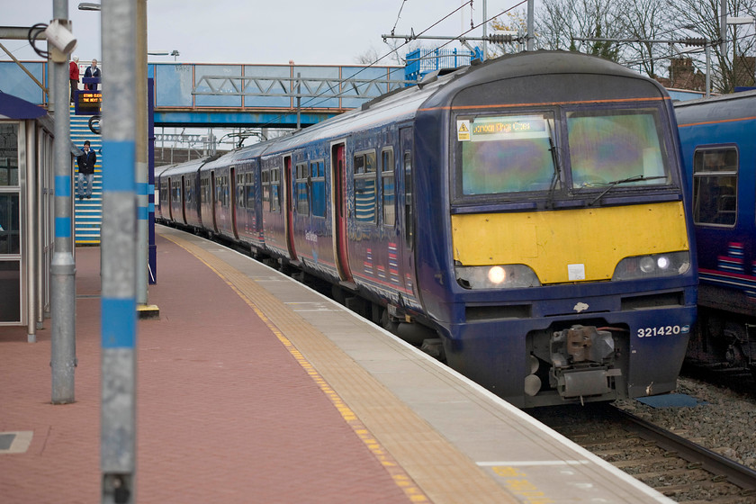 321420 GE 07.55 Cambridge-London King's Cross (2C35), Alexandra Palace station 
 Now running for Great Northern, former Silverlink 321420 arrives at Alexandra Palace station. The unit is working the 07.55 Cambridge to King's Cross service. Thes units entered service in 1988 with the 3214XX subset all first being based at Bletchley for use on the WCML between Euston and Birmingham via Northampton. They moved away when the Class 350s arrived in the late 2000s. The 321s have the odd nickname of 'Dusty Bins' after the animated charterer in the game show 3-2-1! 
 Keywords: 321420 07.55 Cambridge-London King's Cross 2C35 Alexandra Palace station Great Northern Silverlink