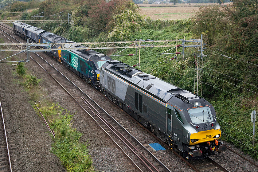 68013, 68002, 37425, 66433 & 66424, 06.50 Crewe Gresty Bridge-Wembley (0A68), Victoria bridge 
 With nearly 16 000hp on-tap, the 06.50 Crewe Gresty Bridge to Wembley yard light engine move passes Victoria bridge between Northampton and Milton Keynes. Leading the convoy is 68013 followed by 68002 'Intrepid', 37425 'Concrete Bob', 66433 and 66424. 
 Keywords: 68013 68002 37425 66433 66424 06.50 Crewe Gresty Bridge-Wembley 0A68 Victoria bridge