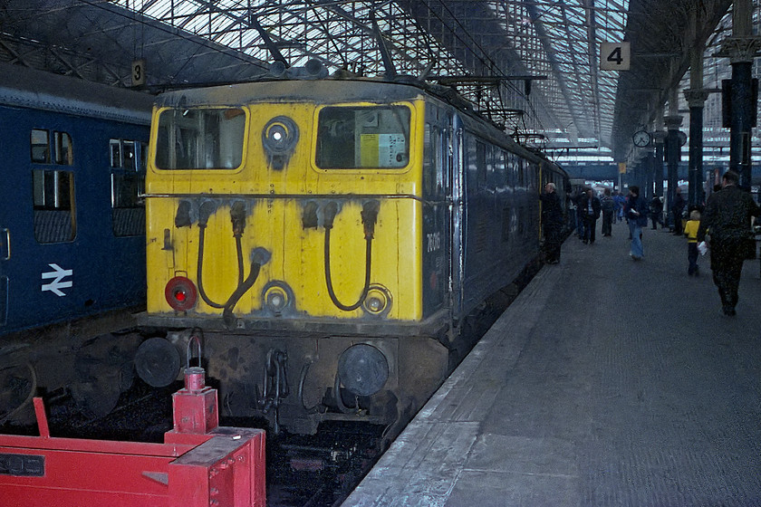 76016 & 76009, return leg of the Pennine Explorer, Rotherwood Exchange sidings-Cardiff Central, Manchester Piccadilly station 
 Having arrived back in Manchester Piccadilly's platform four at just gone 16.30 (according to the station clock) it was dark enough for me to attach the flash to my borrowed Rollie B35 camera. The set up for the flash was a bit odd on the Rollie as the hot shoe was on the base plate of the camera. So, the flash unit hung down rather incongruously whilst taking the picture! 76016 and 76009 are seen on the blocks waiting to be detached from the return Pennine Explorer railtour whilst 40024 was being attached at the other end. 
 Keywords: 76016 76009 Pennine Explorer Rotherwood Exchange sidings-Cardiff Central, Manchester Piccadilly station