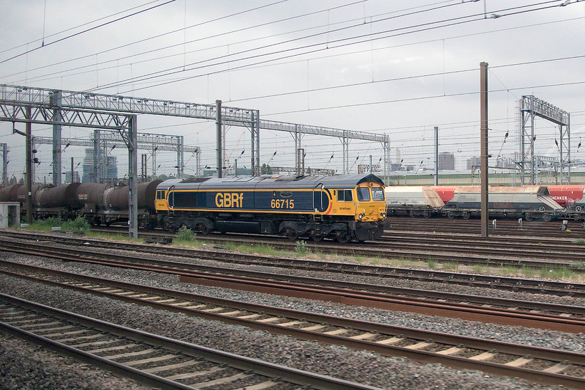 66715, 18.55 Irvine-Dollands Moor (6M74), Wembley yard 
 66715 'Valour' stands in Wembley yard at the head of the 18.55 Irvine to Dollands Moor empty china clay slurry train composed of 'bullet' wagons. After Dollands Moor, the train will continue through the channel tunnel and on to the continent. 
 Keywords: 66715 18.55 Irvine-Dollands Moor 6M74 Wembley yard