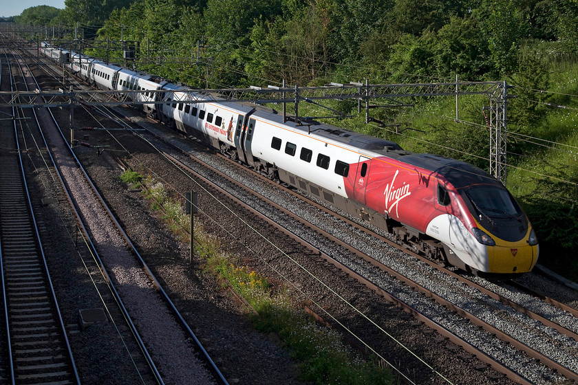 390039, VT 07.03 London Euston-Birmingham New Street (9G04, 2L), Victoria Bridge 
 This 'flying silk' livery looks smart in seeking to copy the livery of the 800s set to join the ECML next year (but ironically not in this livery since the state takeover...hoorah!). But it does reveal how small the windows are on Pendelinos. 390039 passes Victoria Bridge on a glorious summer morning with the 07.03 London Euston to Birmingham New Street. This was one of the services that avoided the huge delays caused by the closure of the Northampton loop line. 
 Keywords: 390039 9G04 Victoria Bridge