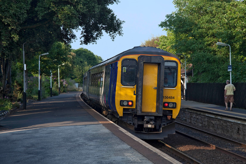 156484, NT 18.02 Barrow-in-Furness-Lancaster (2C34, RT), Kents Bank station 
 As Andy walks along the platform at Kents Bank station, 156484 arrives with the 18.02 Barrow-in-Furness to Lancaster working. Another lovely station that was well tended and situated at a super spot on the edge of Morecambe Bay. 
 Keywords: 156484 2C34 Kents Bank station