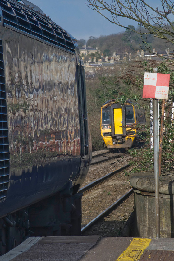 158950, GW 14.42 Gloucester-Westbury (2C20) & 43033, 14.30 London Paddington-Bristol Temple Meads (1C18), Bath Spa station 
 Bath Spa's relatively short platforms are shown clearly in this photograph with the rear power car of the 1C18 14.30 Paddington to Bristol stopping over the edge of the down platform's ramp. This consideration will be important when the new electric trains that will take over the services on the GWML are procured. The power car seen is 43033 'Driver Brian Cooper 15 June 1947-5 October 1999' whilst 158950 leaves with the 2C20 14.42 Gloucester to Westbury 'local' service. 
 Keywords: 158950 14.42 Gloucester-Westbury 2C20 43033 14.30 London Paddington-Bristol Temple Meads 1C18 Bath Spa station Driver Brian Cooper 15 June 1947-5 October 1999 First Great Western HST