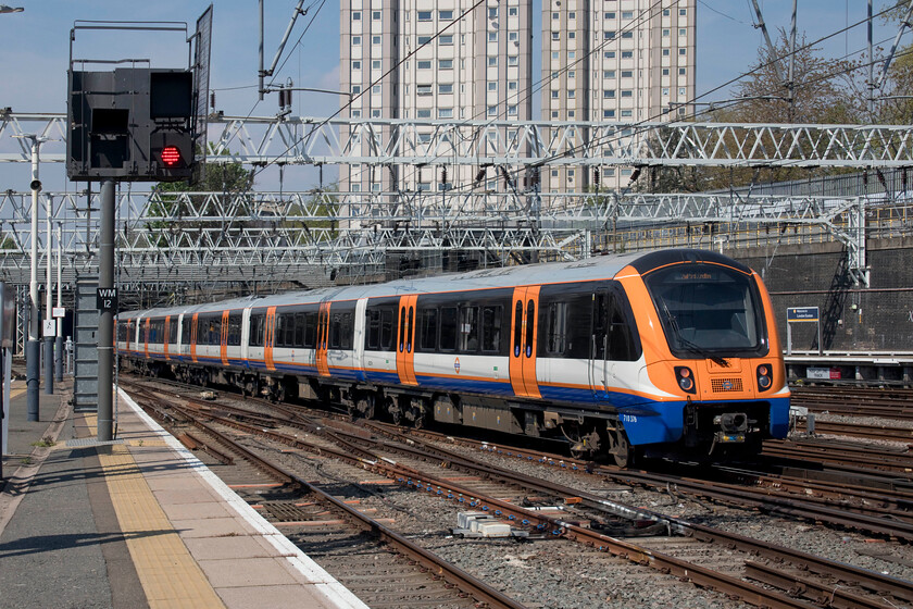 710376, LO 13.00 London Euston-Watford Junction (2D79, 1E), London Euston station 
 The 13.00 Euston to Watford Junction service leaves its starting point worked by 710376. These London Overground units strike quite a pose in their distinctive white, blue and orange livery. 
 Keywords: 710376 13.00 London Euston-Watford Junction 2D79 London Euston station London Overground