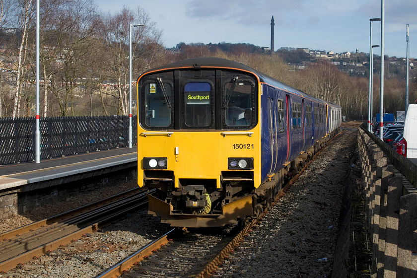 150121 & 150150, NT 13.20 Leeds-Southport (1J17, RT), Sowerby Bridge station 
 With the 275ft Wainhouse Tower dominating the skyline, 151121 leads 150150 into Sowerby Bridge station with the 13.20 Leeds to Southport service. 150150 is one of my most photographed units having captured it at such diverse locations as Carbis Bay in Cornwall, Bradford-on-Avon, Preston and Liverpool! 
 Keywords: 150121 150150 13.20 Leeds-Southport 1J17 Sowerby Bridge station