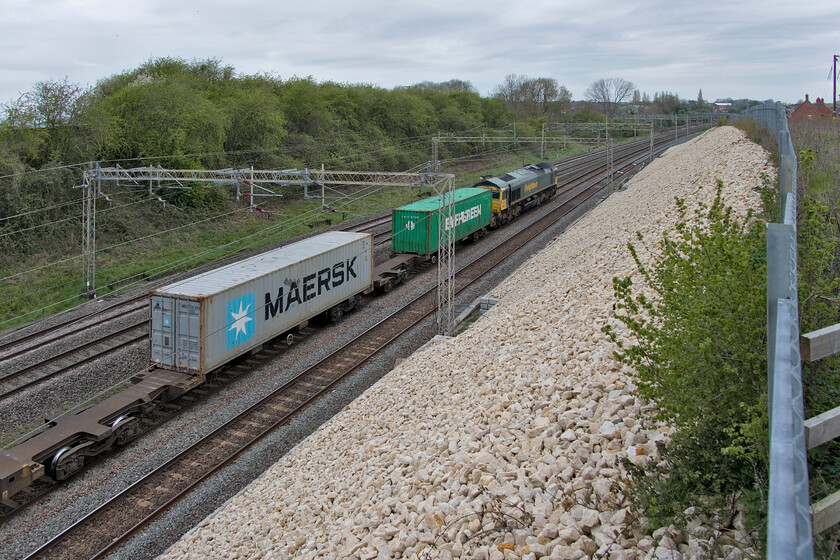 66512, 07.50 Felixstowe North-Lawley Street (4M94, 20E), Ashton Road bridge 
 Unfortunately, my chosen position to photograph the return up Railadventure HST move meant that I could not capture down trains. By utilising the widest angle on my Canon G1X I have created an interesting view of the WCML just south of Roade. It shows Freightliners 66512 leading the 07.50 Felixstowe to Lawley Street. Notice the small and innocent bush growing in the foreground, I think I need to take my loppers with me next time and undertake a little tactical pruning! 
 Keywords: 66512 07.50 Felixstowe North-Lawley Street 4M94 Ashton Road bridge Freightliner