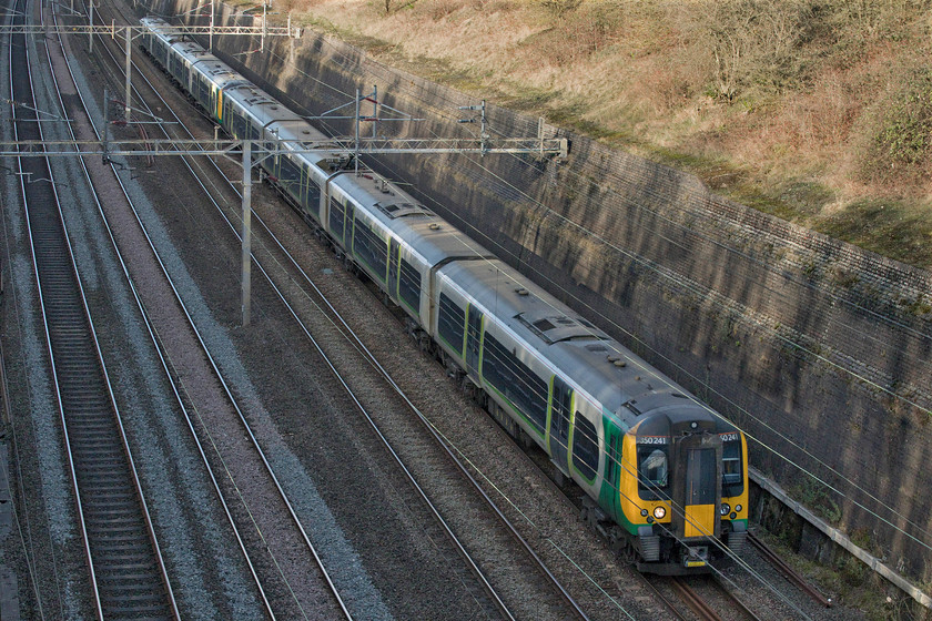 350241 & 350255, LN 12.13 Rugeley Trent Valley-London Euston (1Y24, RT), Roade cutting 
 350241 and 350255 pass through Roade cutting working the 12.13 Rugeley Trent Valley to Euston service. It's early February and the time is 14.30 and the sun has all but disappeared from the depths of the cutting. 
 Keywords: 350241 350255 12.13 Rugeley Trent Valley-London Euston 1Y24 Roade cutting London Northwestern Desiro