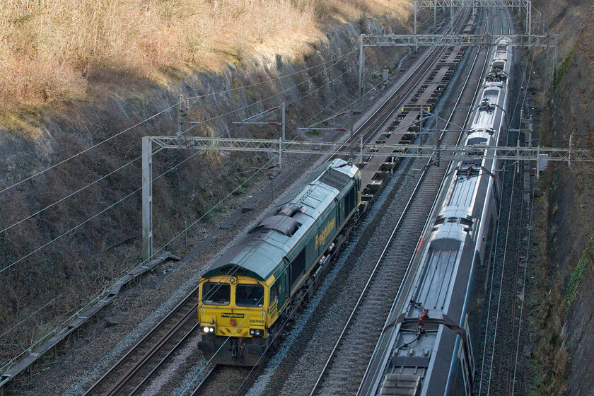 66955, 09.14 Southampton MCT-Garston (4M58, 35E) & 390009, VT 14.07 London Euston-Liverpool Lime Street (1F18, RT), Roade cutting 
 As 390009 'Treaty of Union' sweeps through Roade cutting working Avanti West Coast's 14.07 Euston to Liverpool Lime Street 66955 leads the virtually empty 4M58 09.14 Southampton to Garston Freightliner. Five HGVs could have been utilised to move the entire contents of this train making a bit of a mockery of the arguments of moving freight from road to rail! Something has gone dramatically wrong on the last month or so with many intermodal trains running at incredibly low capacity and I have yet to hear an explanation as to the reason for this. 
 Keywords: 66955 Southampton MCT-Garston 4M58 390009 14.07 London Euston-Liverpool Lime Street 1F18 Roade cutting Freightliner Treaty of Union