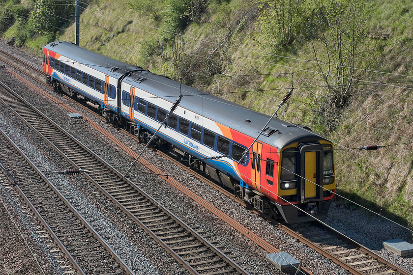 158852, EM 07.57 Norwich-Liverpool Lime Street (1R70, 3L), Essendine TF043129 
 East Midland's two-car 158852 takes the down slow past Essendine at the southern end of Stoke Bank working the 07.57 Norwich to Liverpool service. Much as I quite like the class 158s and their class 159 cousins that are both based on the Mk. III coach, making a 237-mile journey from Norwich to Lime Street is not at all appealing! 
 Keywords: 158852 07.57 Norwich-Liverpool Lime Street 1R70 Essendine TF043129