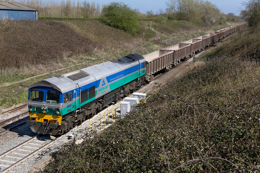 59001, 13.00 Appleford-Whatley Quarry (6C48), Baulking 
 Even though it is now nearly thirty year's old, 59001 is still on the mainline earning its keep! It was a pioneer when it first arrived on our shores in 1986 and I clearly remember seeing it for the first time passing through Westbury station. Here, it is seen passing Baulking with the 6C48 13.00 Appleford to Whatley quarry empty stome train looking very smart in its Aggregate Industries bright blue, turquoise and centre silver striped livery. 
 Keywords: 59001 13.00 Appleford-Whatley Quarry 6C48 Baulking empty stone train