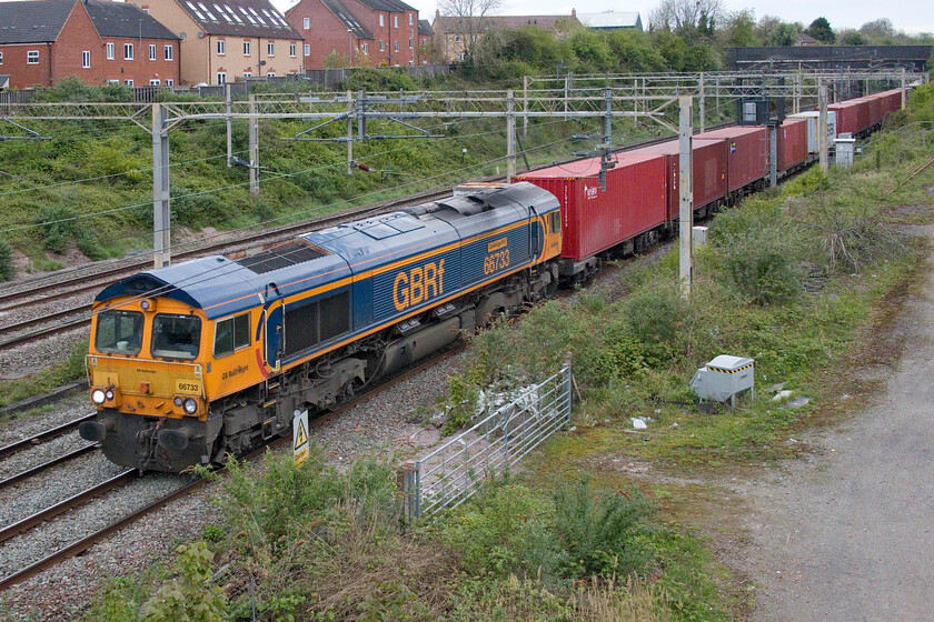 66733, 13.39 Ditton-Felixstowe North (4L62, 13E), site of Roade station 
 Named back in September 2014 66733 'Cambridge PSB' leads the 4L62 13.39 Ditton to Felixstowe service through the village of Roade. This was a total grab shot with me arriving at the bridge to hear the train approaching giving me just enough time to power up the camera and hold it 'blind' over the parapet and press the shutter. Apart from a little straightening up and cropping this is as it was taken! 
 Keywords: 66733 13.39 Ditton-Felixstowe North 4L62 site of Roade station Cambridge PSB