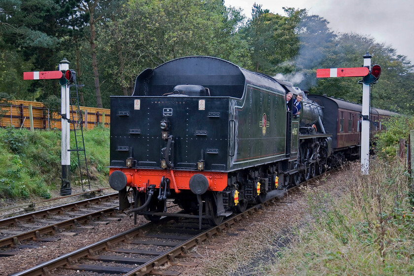 44767, 11.15 Holt-Sheringham, Weybourne station 
 I am not a fan of tender first photographs but when framed by two superb GNR somersault signals such as these it's worthwhile! Black 5 44767 'George Stephenson' arrives at Weybourne easing the 11.15 Holt to Sheringham into the station whilst the footplate crew look on carfully! 
 Keywords: 44767 11.15 Holt-Sheringham Weybourne station George Stephenson