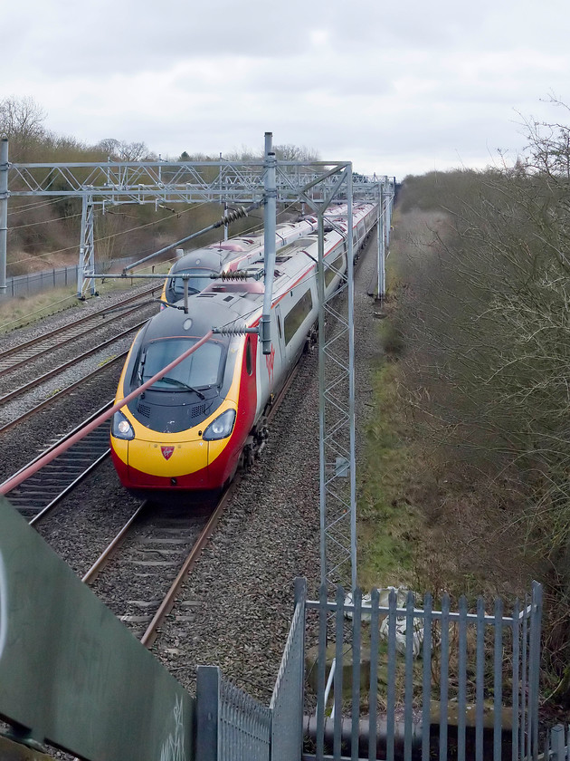 390154, VT 10.38 Liverpool Lime Street-London Euston (1A14, 9E) & class 390, VT 11.50 London Euston-Brimingham New Street (9G08, RT), Bradwell SP831391 
 Two class 390 Pendolinos cross at Bradwell just north of Milton Keynes station. On the down fast to the right is an unidentified member of the class working the 11.50 London Euston to Birmingham New Street. On the up fast is 390154 'Matthew Flinders' forms the 10.38 Liverpool Lime Street to Euston. 
 Keywords: 390154,_VT_10.38_Liverpool_Lime_Street-London_Euston_(1A14,_9E)_&_class_390,_VT_11.50_London_Euston-Brimingham_New_Street_(9G08,_RT),_Bradwell_SP831391.jpg