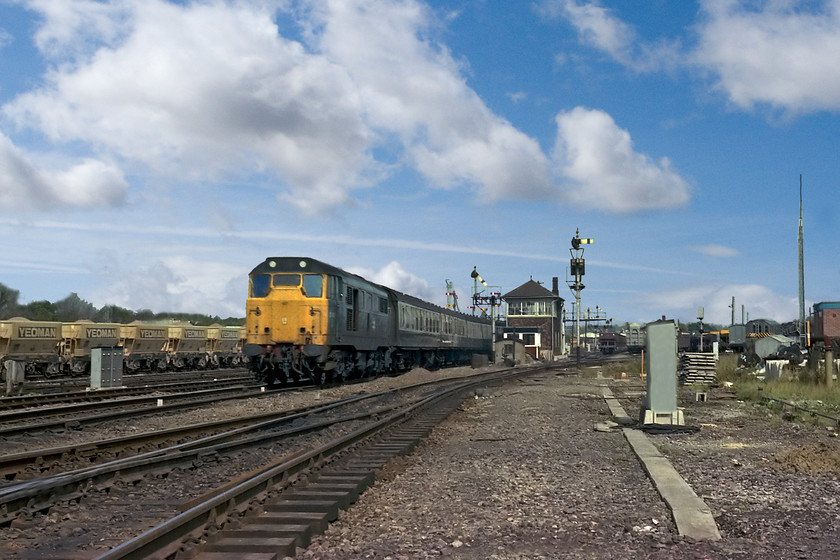 31401, 13.00 Bristol Temple Meads-Portsmouth Harbour, Westbury South yard 
 31401 accelerates hard away from Westbury with the 13.00 Bristol Temple Meads to Portsmouth Harbour as it prepares to climb the four-mile long 1:70 Upton Scudamore bank. Duncan and I are standing in Westbury South Yard with the signal box in view; quite how we managed this I do not know! Perhaps the signalman had lost interest in chasing off some young spotters as the box had only a week left in use before abolition. This would render it redundant with it being pulled down soon afterwards and the sweeping away of all the superb semaphores at this location. 
 Keywords: 31401 13.00 Bristol Temple Meads-Portsmouth Harbour Westbury South yard