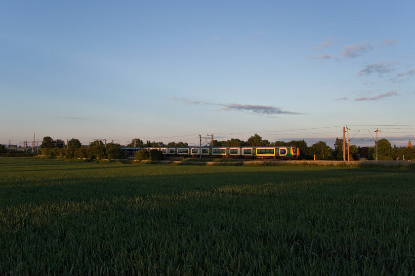 Class 350s, LN 04.52 Northampton EMD-Milton Keynes Central (5Y32, RT), Milton Malsor SP740557 
 The quality of light is very special just after sunrise as seen here near the Northamptonshire village of Milton Malsor. A pair of London Northwestern Desiros pass southwards as the 04.52 Northampton EMUD (King's Heath) to Milton Keynes empty stock working. This train almost prevented me from capturing the previous northbound working seen in the previous image passing seconds after the charter stock had gone out of view. 
 Keywords: Class 350s 04.52 Northampton EMD-MKC (5Y32, RT), Milton Malsor SP740557 London Northwestern Desiro