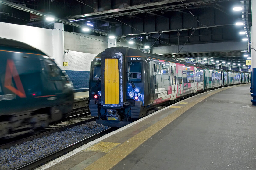 350108, LN 11.23 London Euston-Birmingham New Street (1Y31, 2L) & 390151, VT 11.13 London Euston-Manchester Picadilly (1H16, 23L), London Euston station 
 As 390151 gets away from Euston on time working the 11.13 service to Manchester our train home to Northampton waits at the adjacent platform. My wife and were to travel aboard 350108 working the 11.23 Birmingham train as far as Northampton. Unusually, the train was timetabled to depart from platform two at the far easterly side of the dark cavern that is Euston station! 
 Keywords: 350108 11.23 London Euston-Birmingham New Street 1Y31 390151 11.13 London Euston-Manchester Picadilly 1H16 London Euston station London Northwestern Desiro AWC Avanti West Coast Pendolino