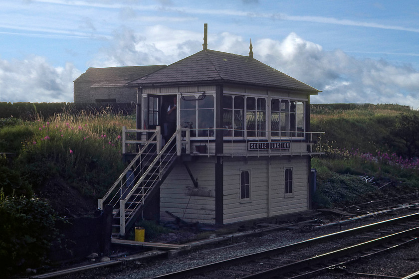 Settle Junction signal box (Midland, 1913) 
 The superb Settle Junction signal box stands proudly in almost the dry stone walls and stone barns of North Yorkshire. The 1913 Midland structure still retains its wooden nameboard and finals, the nearest of which is obscured by a miss-placed telegraph pole. At the time of writing, this box is still in operation with very little changes during intervening forty years. My 2014 photograph reveals that the only real differences are prolific tree growth behind the signal box. 
 Keywords: Settle Junction signal box