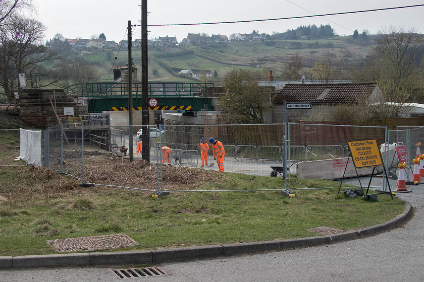 Bridge replacement, Castleton 
 The engineering and construction team are clearing the site around work undertaken to replace the over bridge just west of Castleton station. Looking at the work remaining I suspect that, subject to inspection and certification, the road would re-open within a day or two of this picture was taken. The whole bridge has been replaced following very serious damage inflicted a year earlier by a skip lorry striking the bridge. The force of the strike was so severe that images on the Network Rail website show the track misaligned. A huge amount of work also appeared to have been done securing the piers of the bridge with cabling drilled into the ground. I hope that the skip lorry had good insurance! 
 Keywords: Bridge replacement, Castleton