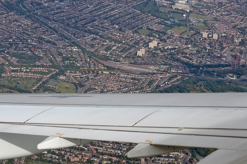 Bounds Green depot, from flight SU2582 
 As our Aeroflot flight descended for its approach to Heathrow, after flying in westwards over south Essex and north London, it turned one hundred and eighty degrees and headed east again. It is just about to complete its turn in this photograph and below is Bounds Green depot and the ECML. Close examination reveals lines of Virgin Mk. IV sets outside of the depot. The line heading off to the northeast is Hertford loop with the ECML largely out of sight in the Wood Green tunnels under the trees to the left. 
 Keywords: Bounds Green depot from flight SU2582