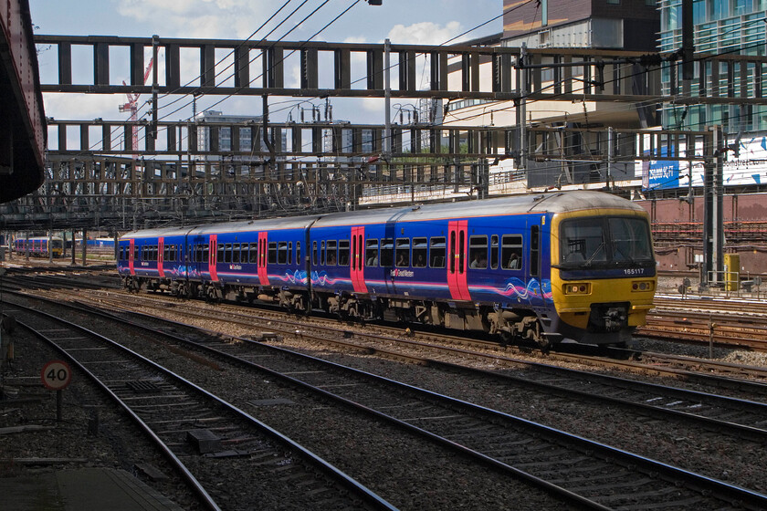 165117, GW 12.01 Oxford-London Paddington & 165127, GW 11.37 Oxford-London Paddington, London Paddington Station 
 A pair of FGW Thames Turbo units that both originated from the same station approach Paddington travelling cautiously through the throat. In the background 165127 is working the 11.37 stopper from Oxford whilst nearest the camera 165117 approaches having worked the 12.01 'fast' service. In the not-too-distant past the fast services were operated by Network SouthEast using sets of proper coaching stock hauled by a Class 50 or a 47; those were the days! 
 Keywords: 165117 12.01 Oxford-London Paddington 165127 11.37 Oxford-London Paddington, London Paddington Station FGW Turbo Thames Turbo First Great Western