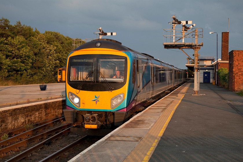 156443, NT 20.20 Barrow-in-Furness-Carlisle (2C51, 4L) & 185127, NT 17.42 Manchester Airport-Barrow-in-Furness (1C54, 3L), Barrow-in-Furness station 
 185127 draws out of Barrow-in-Furness station having arrived with the 1C54 from Manchester Airport. Notice that the miniature calling-on signal is raised allowing the train to pass the down starter at danger so it could make the short journey to the carriage sidings just behind where I am standing where it would be serviced and prepared for its next service. There are dramatic skies above the station, the very hot and humid weather was on the cusp of a change! 
 Keywords: 156443 2C51 185127 1C54 Barrow-in-Furness station