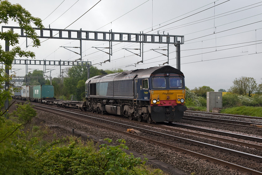 66415, 04.25 Felixstowe-Lawley Street (4M88), Ashton Road Bridge 
 66415 brings the 04.25 Felixstowe North to Lawley Street (Birmingham) Freightliner past Roade in Northamptonshire. This 4M88 is a regular Saturday morning working and can be fully loaded but not today; there were a lot of empty flat wagons. 
 Keywords: 66415 4M88 Ashton Road Bridge