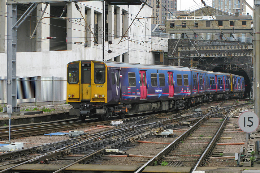 313043, GN 11.30 Stevenage-London KIng`s Cross (2D29), London King`s Cross station 
 313043 still in its First Capital Connect livery arrives into King's Cross with the 11.30 from Stevenage. Notice the crudely applied Great Northern branding vinyl on the side of the lead carriage. Govia is the parent company of Great Northern who took over the franchise in September last year so it is clear that they are making slow progress re-branding their many trains. 
 Keywords: 313043 11.30 Stevenage-London KIng`s Cross 2D29 London King`s Cross station