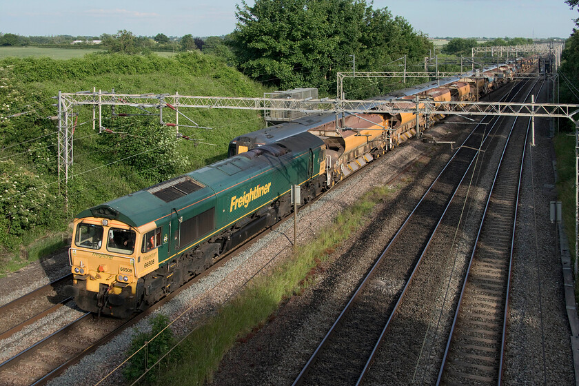 66508, 17.56 Bletchley flyover-Bescot (6Y55, 18L), Victoria bridge 
 An unusual working for a weekday, normally confined to Sundays, was the 6Y55 17.56 Bletchley flyover to Bescot engineering train. The rake of empty eight eight-ton tonne HQA (E) auto discharge bogie ballast wagons are seen passing Victoria bridge between Roade and Ashton with 66508 leading the train. Given its origin, I suspect that the train was involved in ballasting of the East-West Railway somewhere between Bletchley and Bicester with work continuing to reopen the route be it pitifully slowly! 
 Keywords: 66508 17.56 Bletchley flyover-Bescot 6Y55 Victoria bridge Engineering train