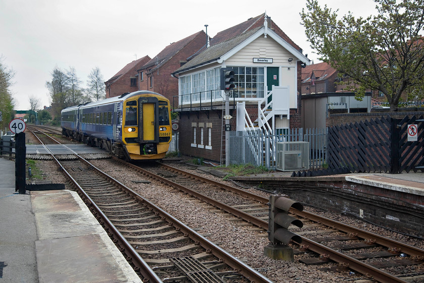 158867, NT 13.30 Hull-Scarborough (1G12, RT), Beverley station 
 158867 arrives at Beverley station crossing the town's busy level crossing. The train is passing the 1911 North Eastern signal box that no controls a whole host of colour lights as seen in this picture. 
 Keywords: 158867 13.30 Hull-Scarborough 1G12 Beverley station